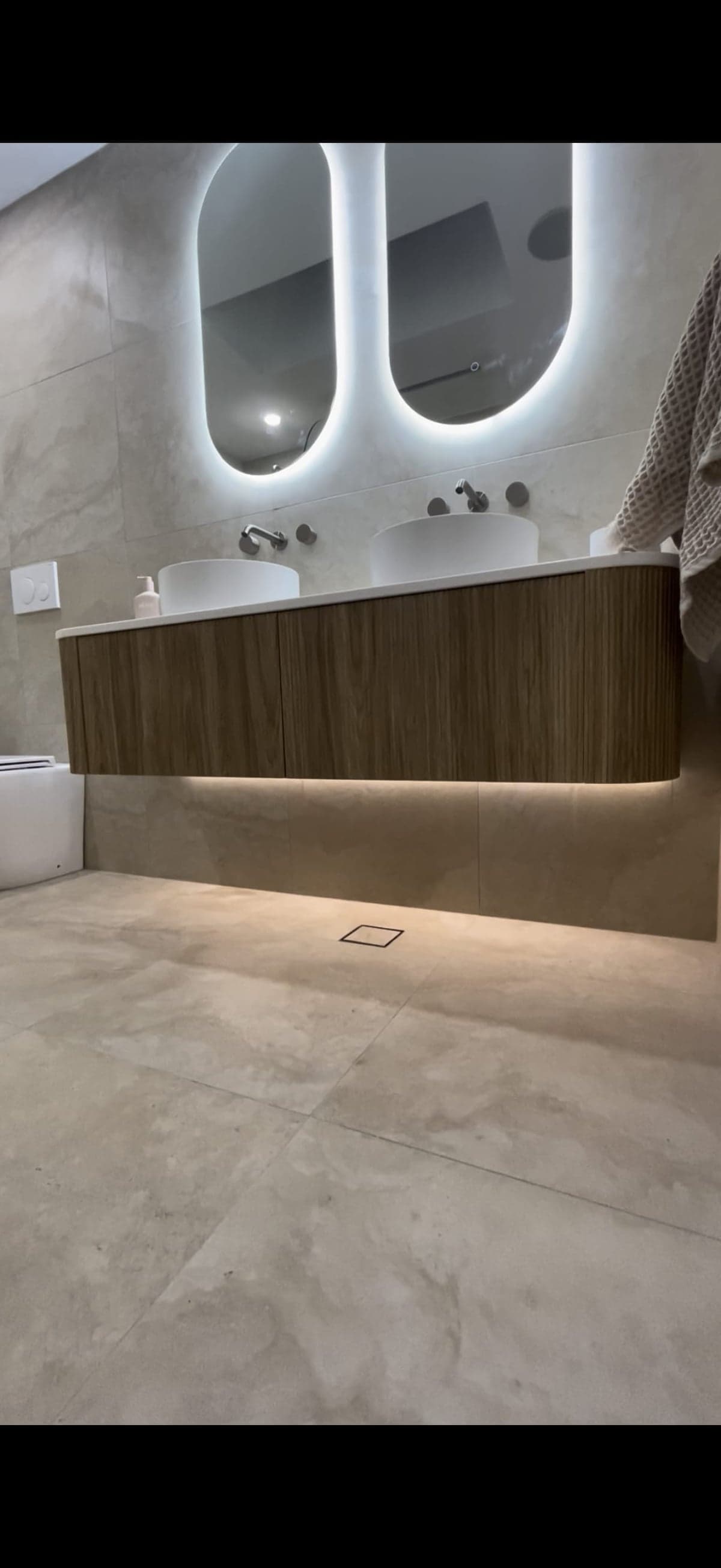 Bright bathroom with skylight, rain shower and black fixtures